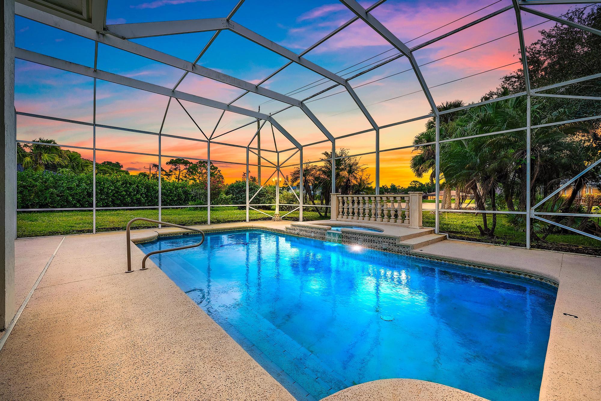19558 Red Gum Trail Jupiter, FL 33458 - Photo 2 of 34 a view of a swimming pool with a porch