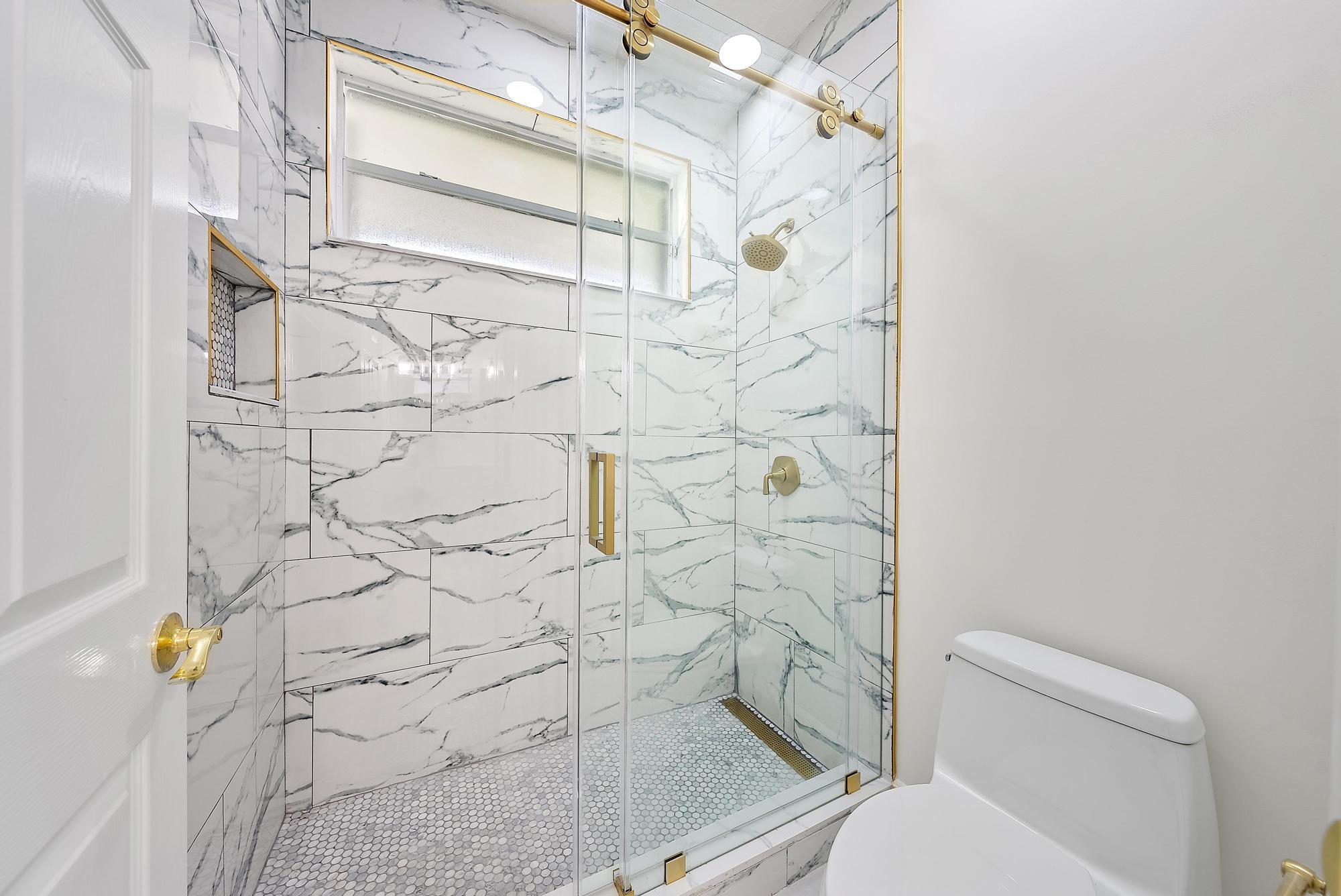 19558 Red Gum Trail Jupiter, FL 33458 - Photo 21 of 34 a bathroom with a toilet and a shower