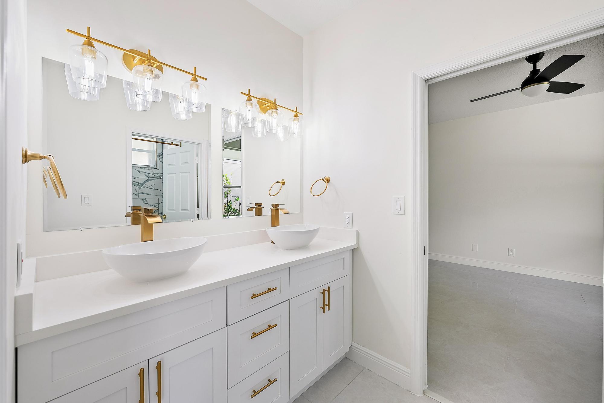 19558 Red Gum Trail Jupiter, FL 33458 - Photo 22 of 34 a bathroom with a sink and a mirror