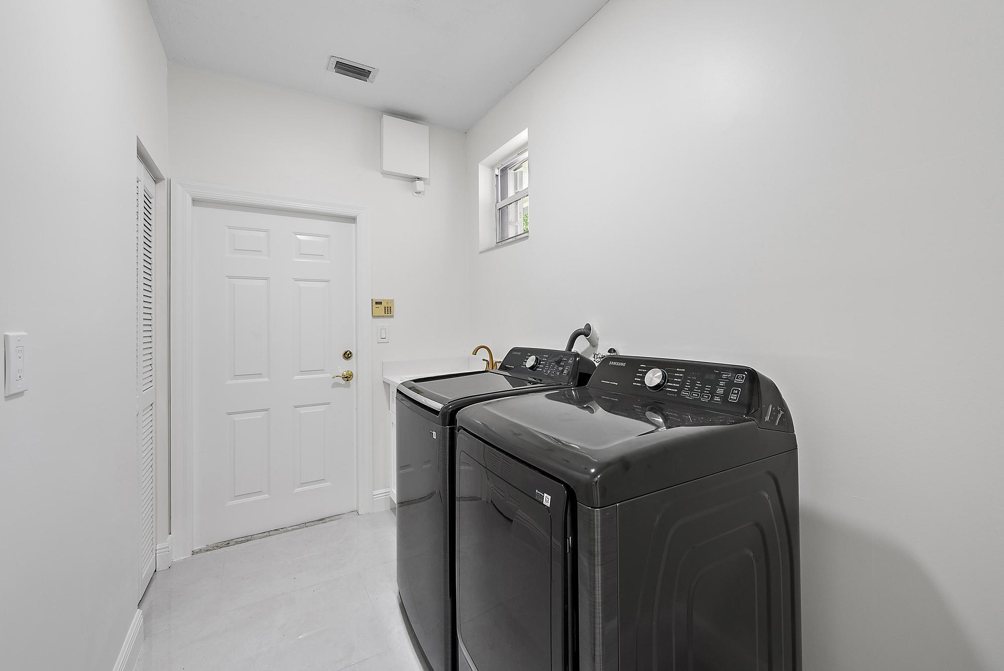 19558 Red Gum Trail Jupiter, FL 33458 - Photo 24 of 34 a utility room with sink dryer and washer