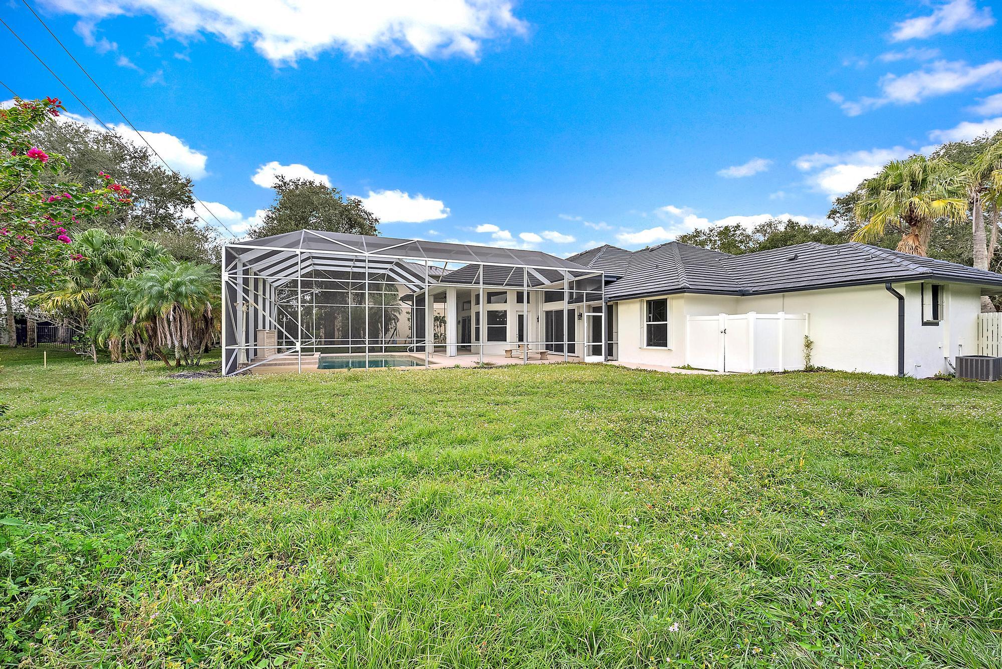 19558 Red Gum Trail Jupiter, FL 33458 - Photo 29 of 34 a front view of a house with a garden