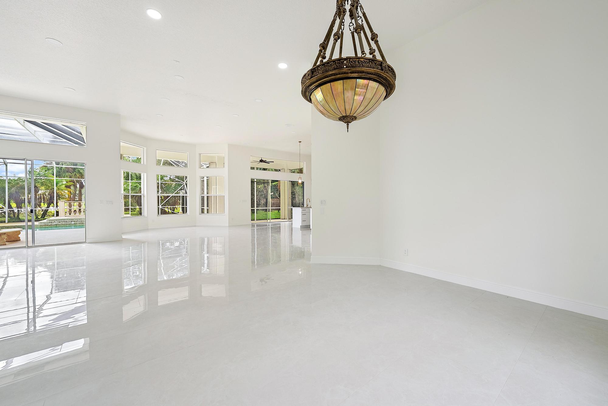 19558 Red Gum Trail Jupiter, FL 33458 - Photo 8 of 34 a view of empty room with wooden floor and fan