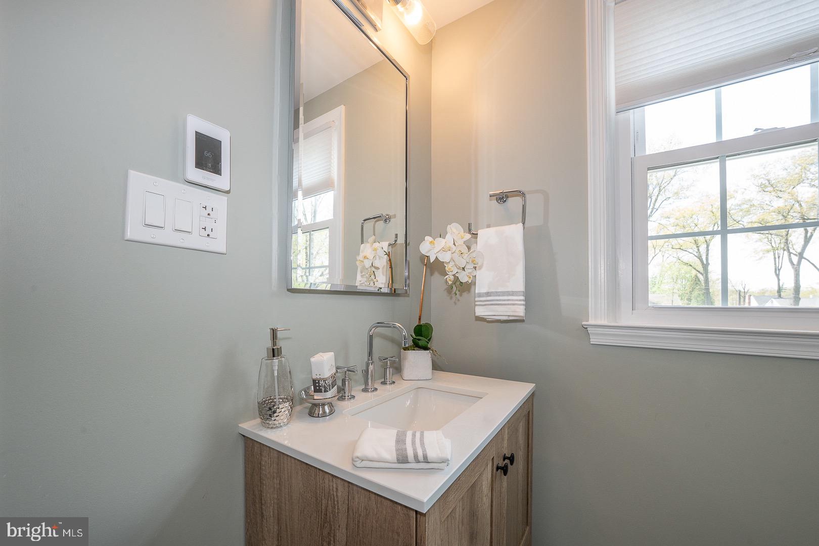 621 Vassar Road Wayne, PA 19087 - Photo 26 of 37 a bathroom with a sink vanity and a mirror