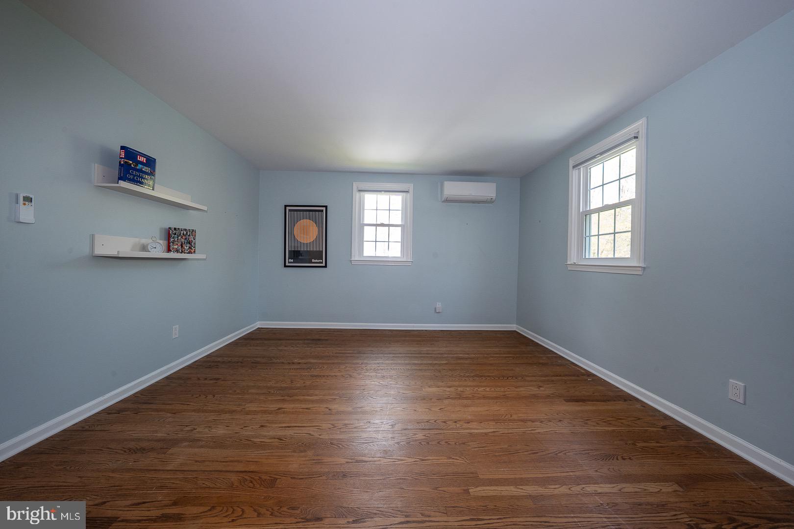 621 Vassar Road Wayne, PA 19087 - Photo 28 of 37 an empty room with wooden floor and windows