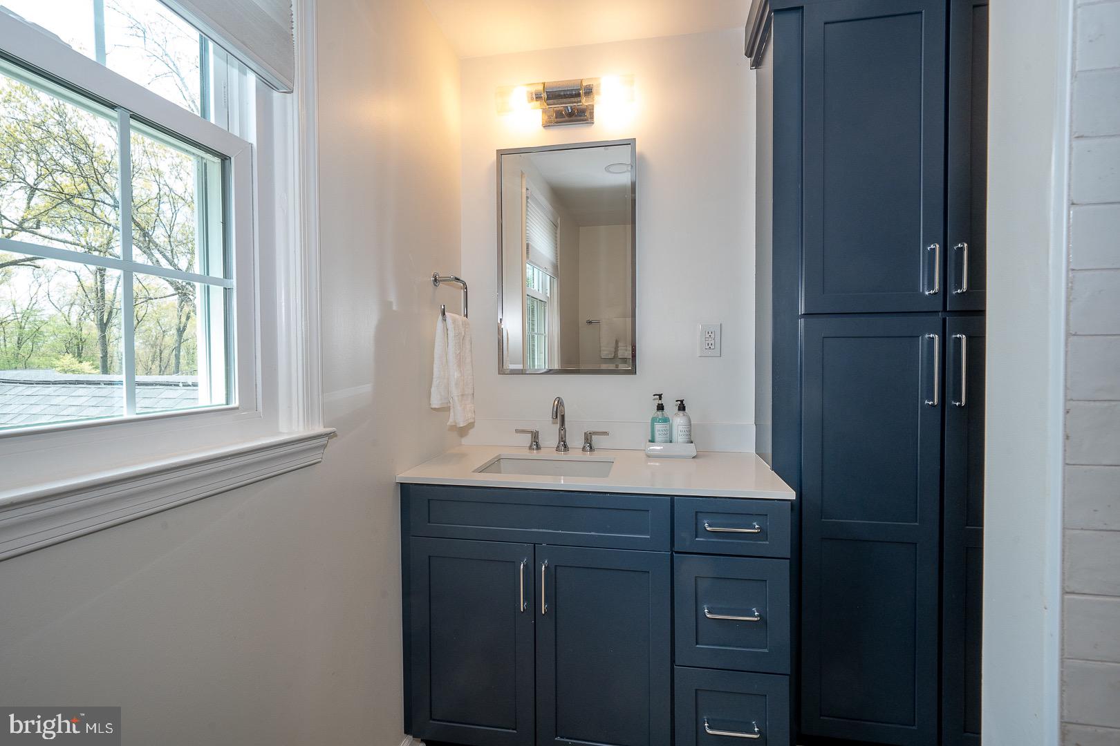 621 Vassar Road Wayne, PA 19087 - Photo 29 of 37 a bathroom with a sink and a mirror