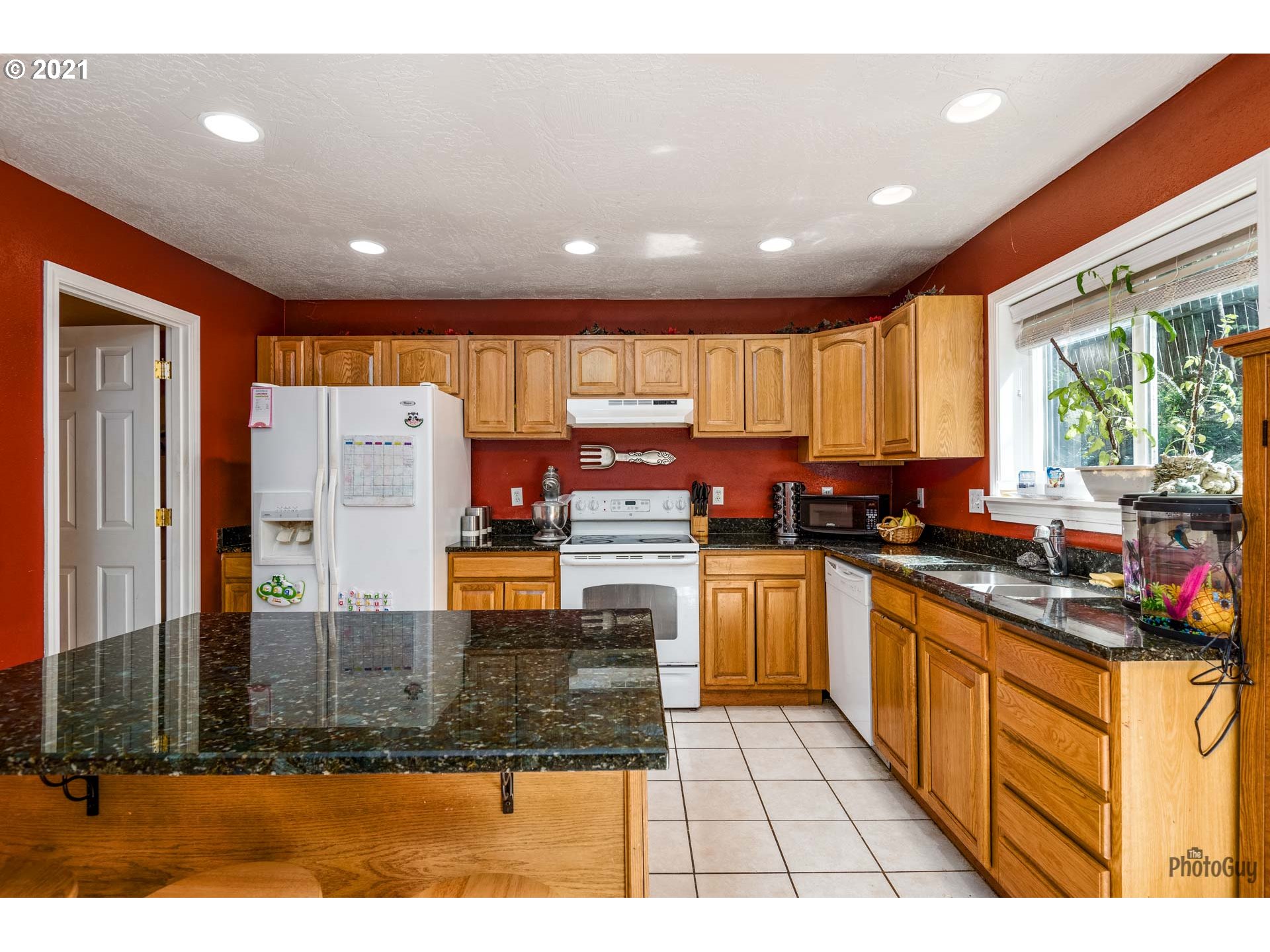 7277 Forsythia Street Springfield, OR 97478 - Photo 13 of 29 a kitchen with stainless steel appliances granite countertop a stove a sink and a refrigerator