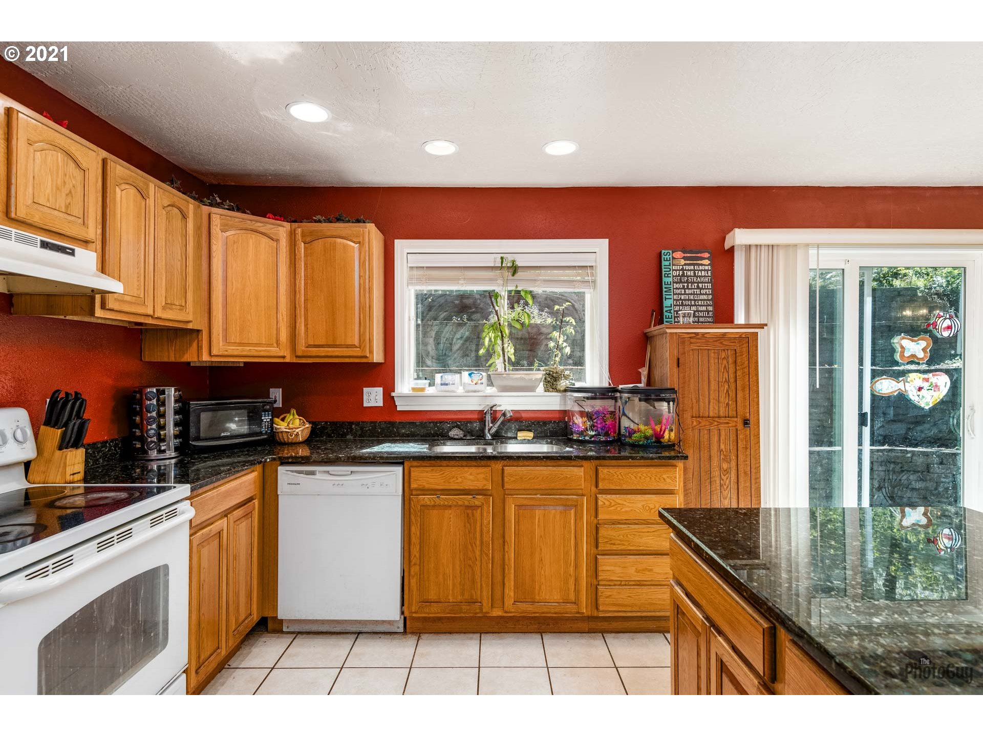 7277 Forsythia Street Springfield, OR 97478 - Photo 14 of 29 a kitchen with stainless steel appliances granite countertop a stove a sink and a microwave