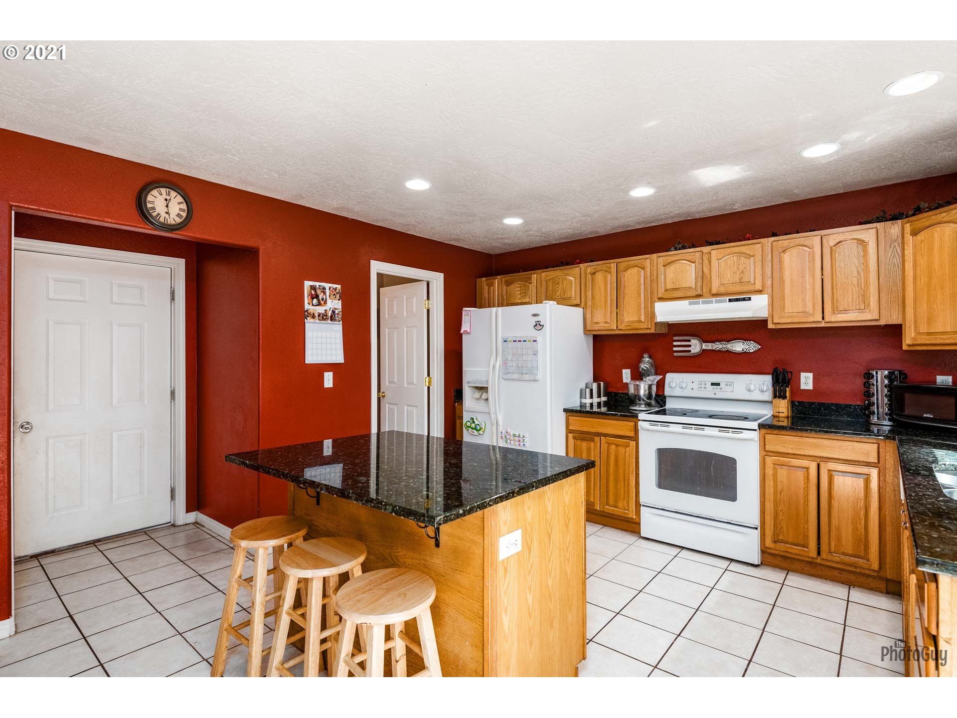 7277 Forsythia Street Springfield, OR 97478 - Photo 15 of 29 a kitchen with stainless steel appliances granite countertop a stove a sink and a microwave