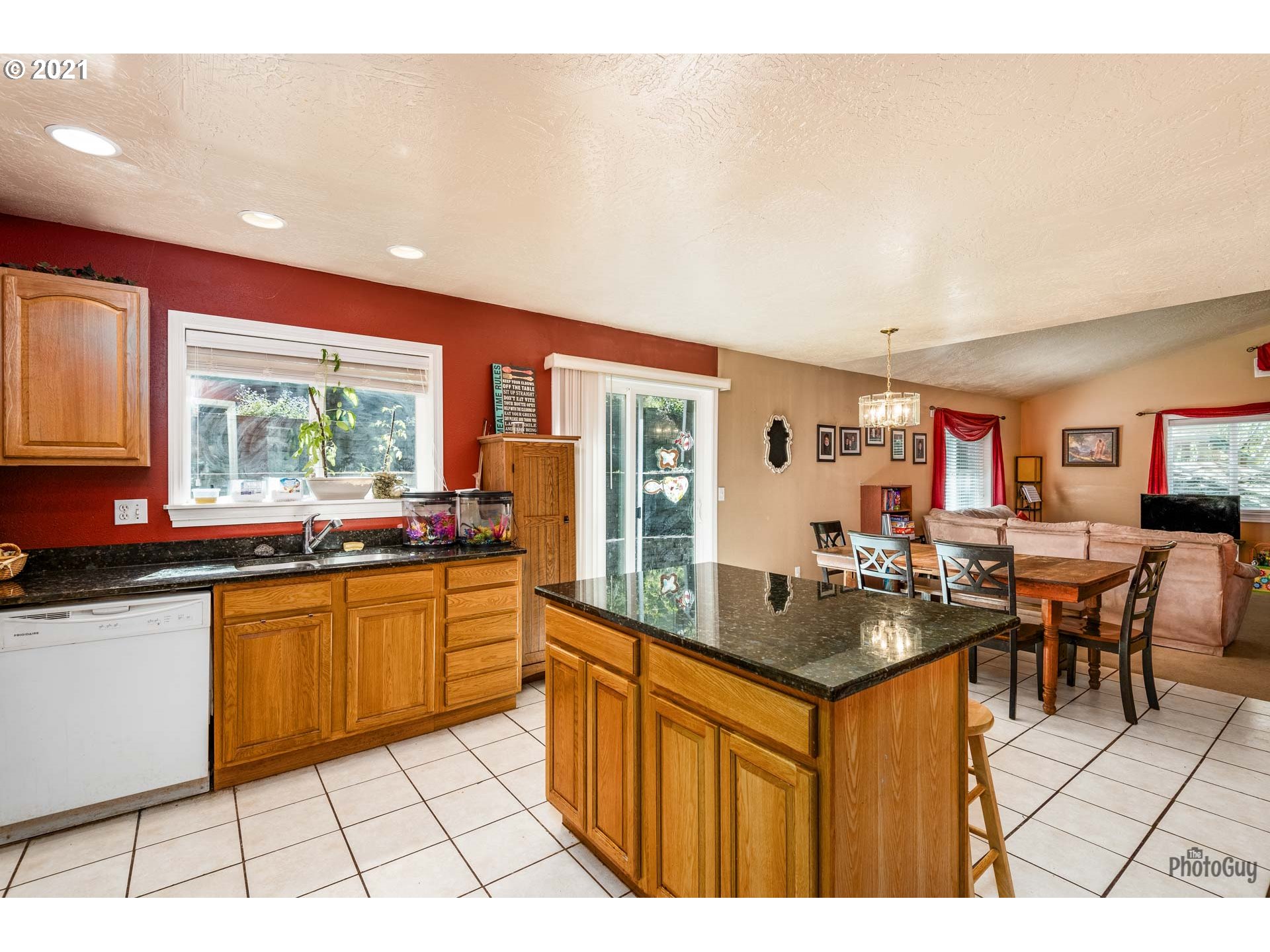 7277 Forsythia Street Springfield, OR 97478 - Photo 16 of 29 a kitchen with stainless steel appliances granite countertop a stove top oven a sink dishwasher and cabinets with wooden floor