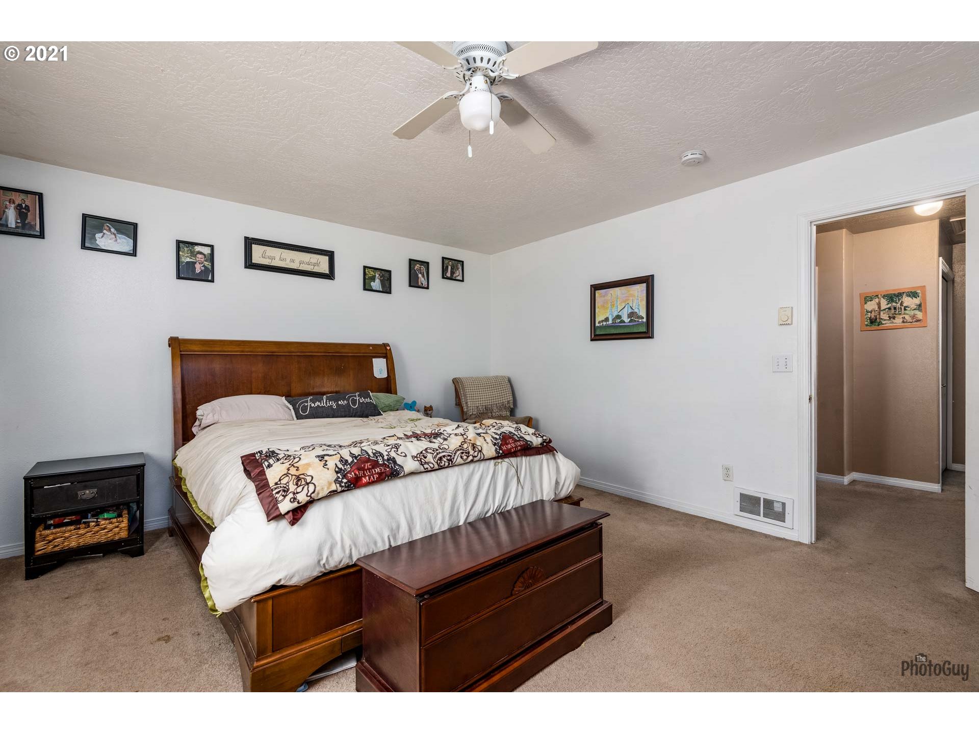 7277 Forsythia Street Springfield, OR 97478 - Photo 20 of 29 a bedroom with a bed a ceiling fan and a dresser