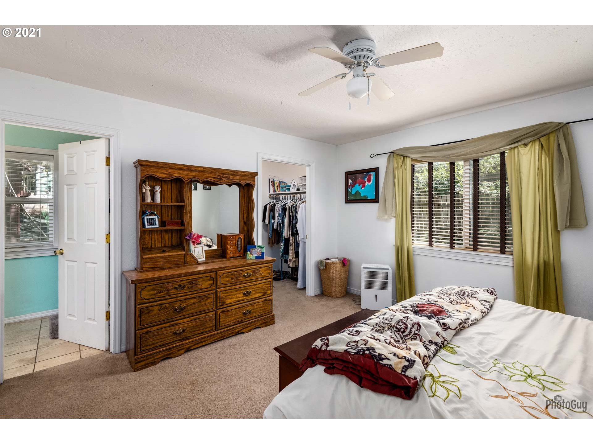7277 Forsythia Street Springfield, OR 97478 - Photo 22 of 29 a bedroom with a large bed and a chandelier