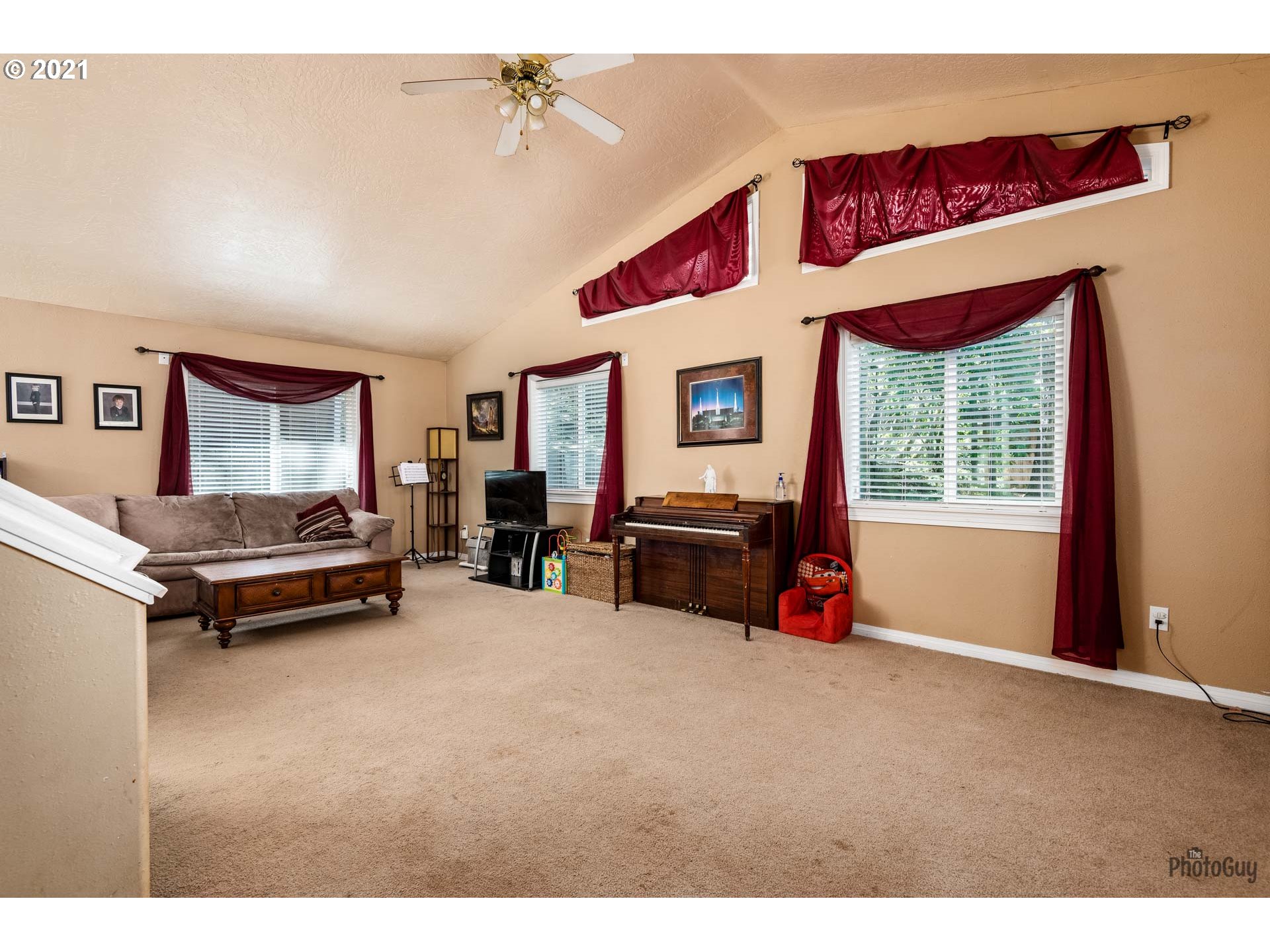 7277 Forsythia Street Springfield, OR 97478 - Photo 7 of 29 a living room with furniture and a flat screen tv