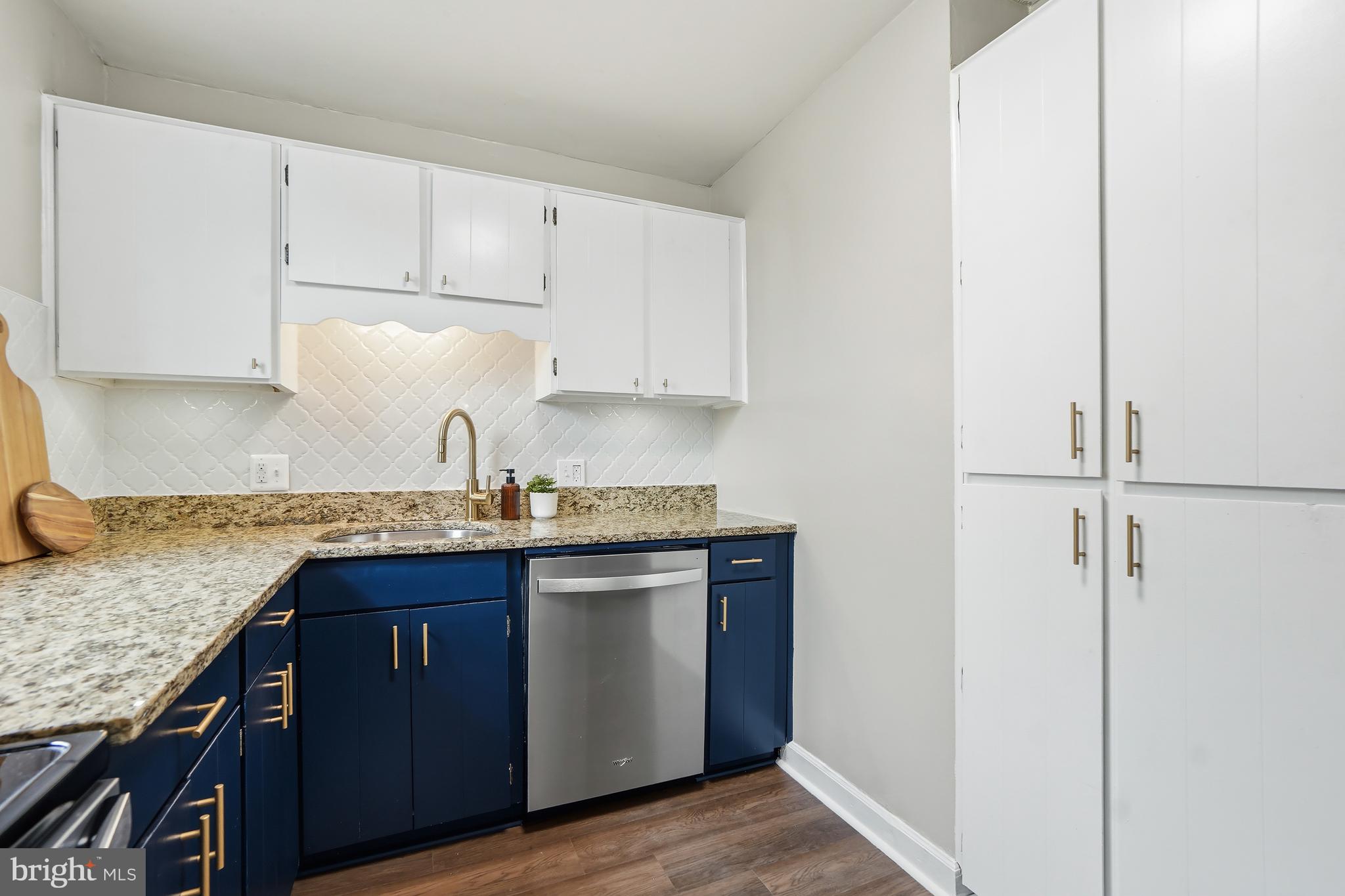 4905 29th Road South, Unit B1 Arlington, VA 22206 - Photo 12 of 52 a kitchen with granite countertop a sink stove and cabinets