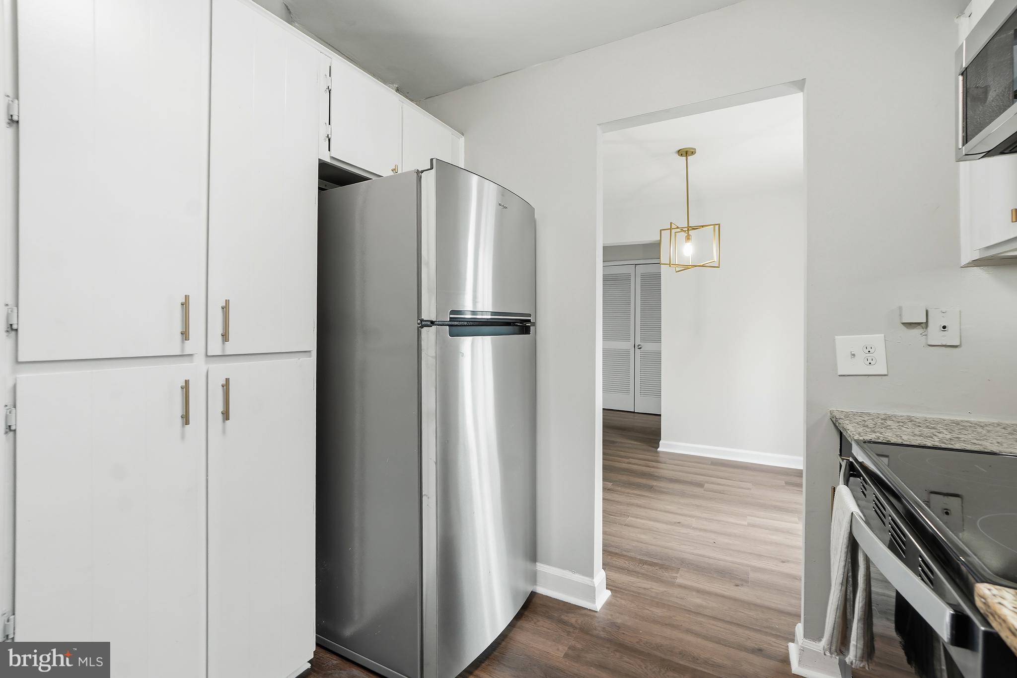 4905 29th Road South, Unit B1 Arlington, VA 22206 - Photo 14 of 52 a kitchen with stainless steel appliances a refrigerator and wooden floor