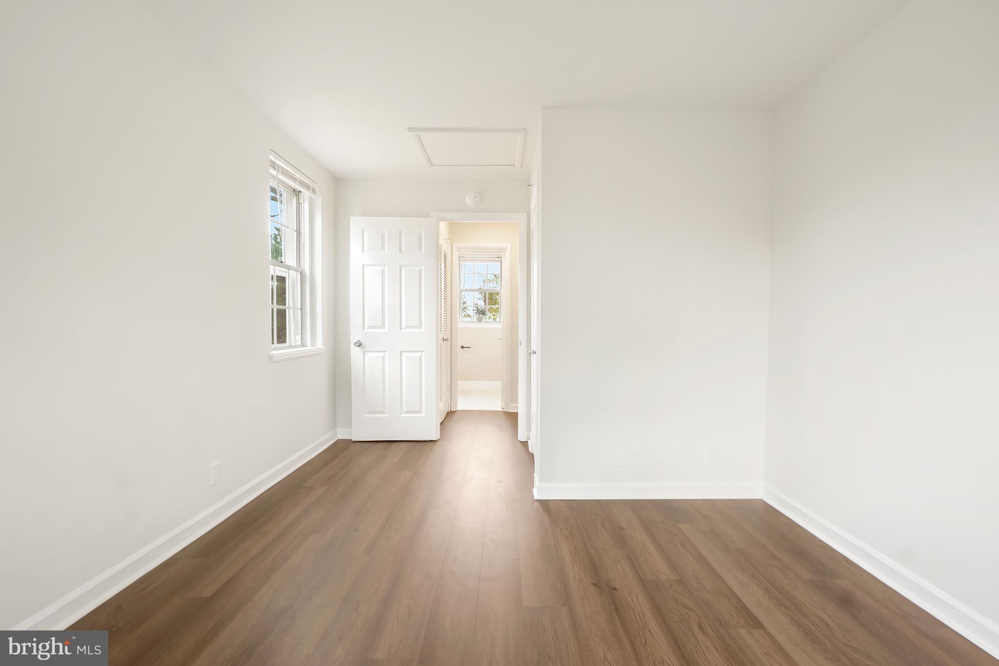 4905 29th Road South, Unit B1 Arlington, VA 22206 - Photo 15 of 52 a view of an empty room with wooden floor and a window