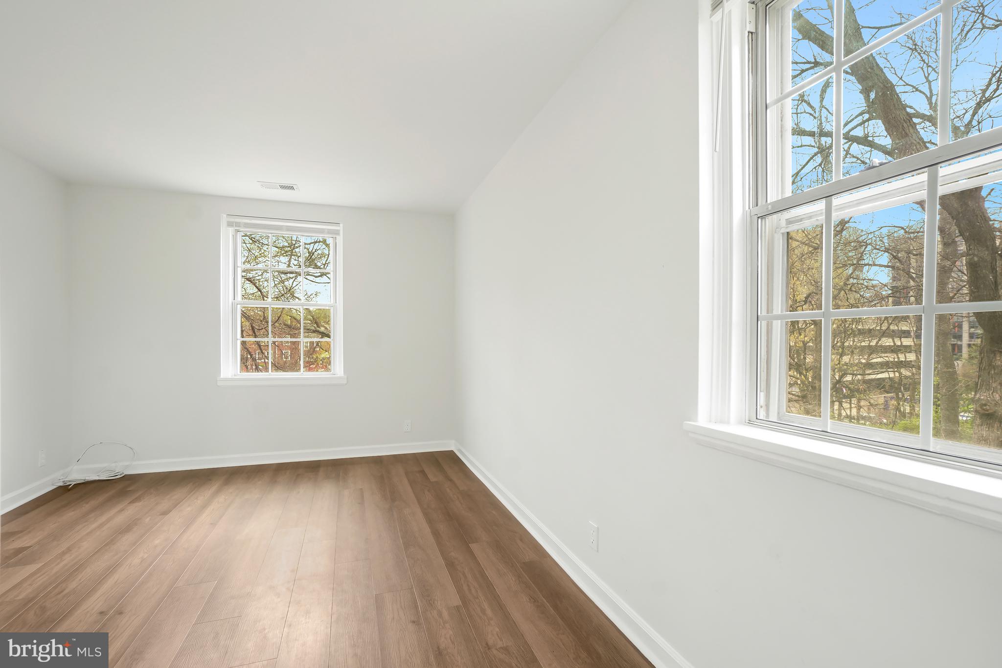 4905 29th Road South, Unit B1 Arlington, VA 22206 - Photo 16 of 52 an empty room with wooden floor and windows