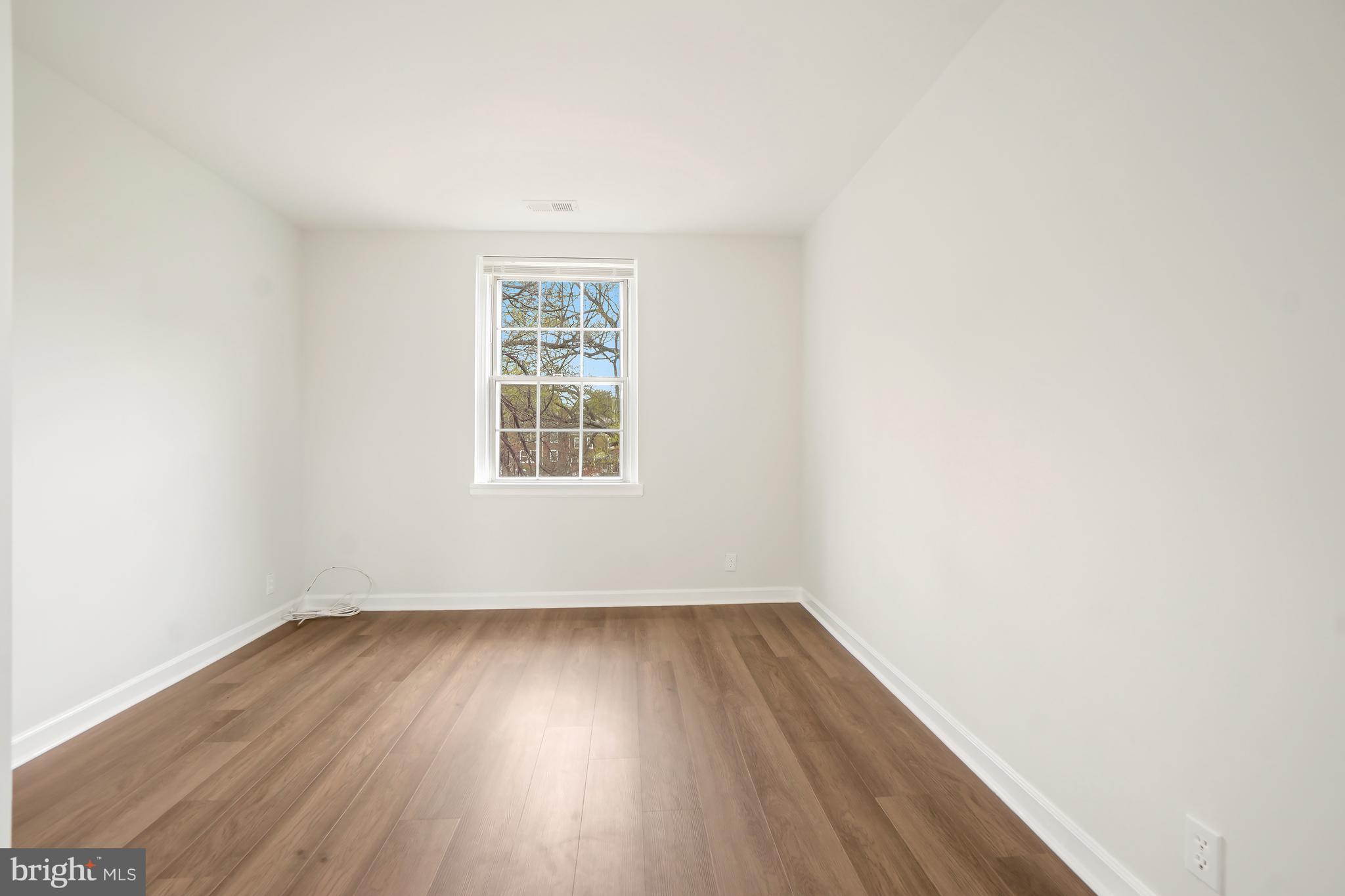 4905 29th Road South, Unit B1 Arlington, VA 22206 - Photo 17 of 52 an empty room with wooden floor and windows