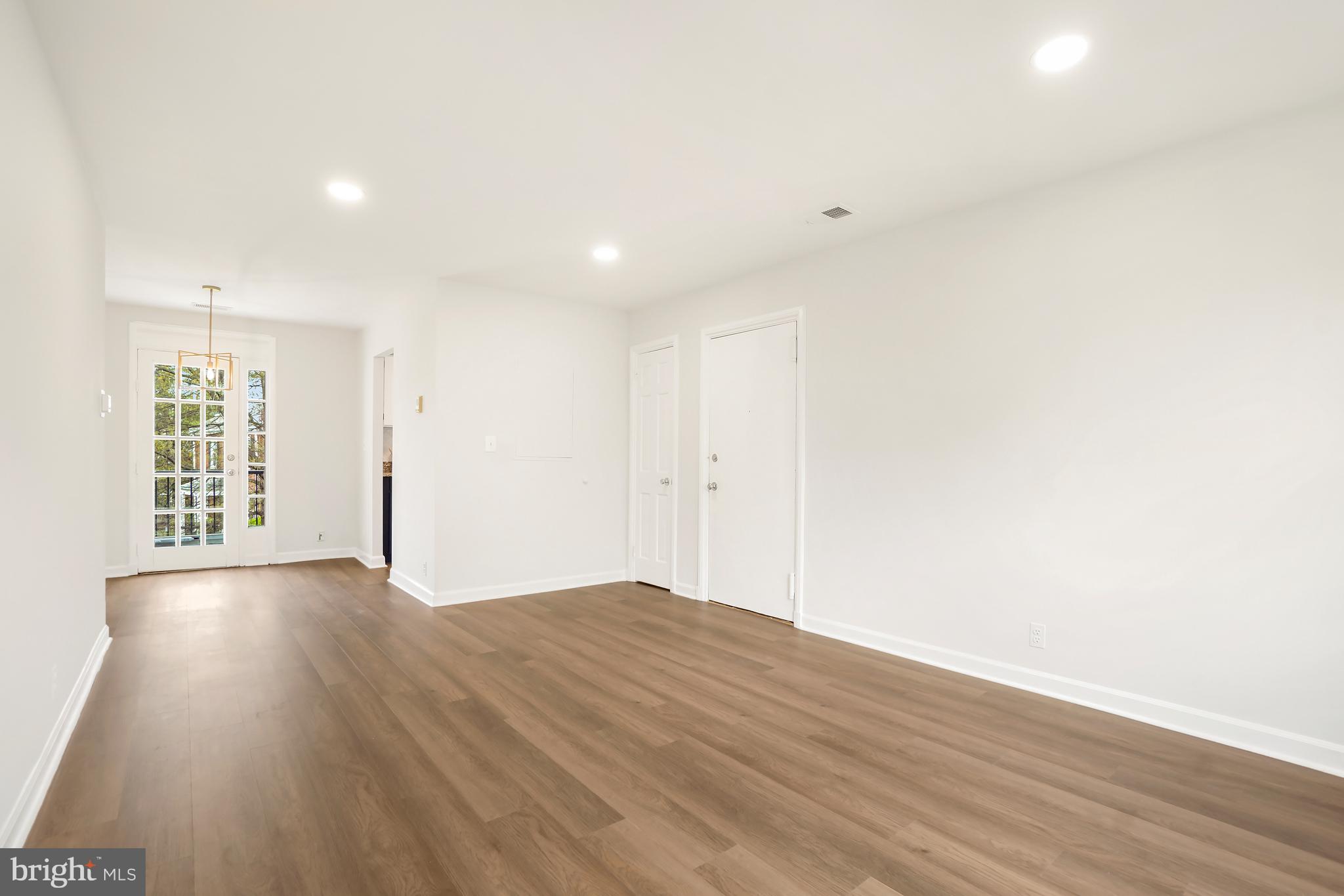 4905 29th Road South, Unit B1 Arlington, VA 22206 - Photo 2 of 52 a view of an empty room with wooden floor and a window