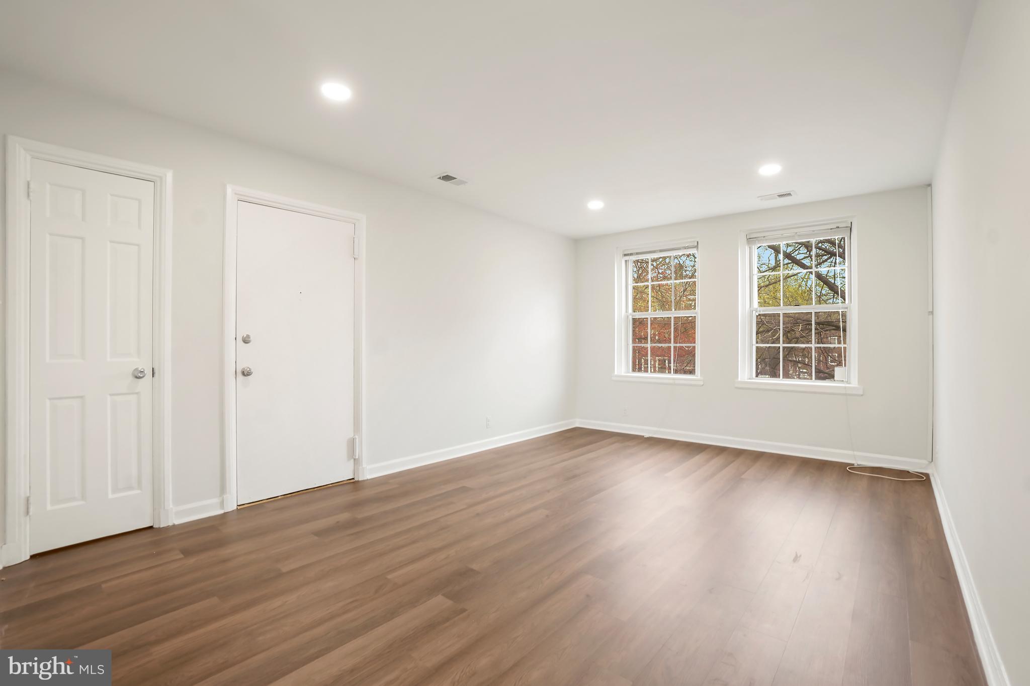 4905 29th Road South, Unit B1 Arlington, VA 22206 - Photo 4 of 52 a view of an empty room with wooden floor and windows