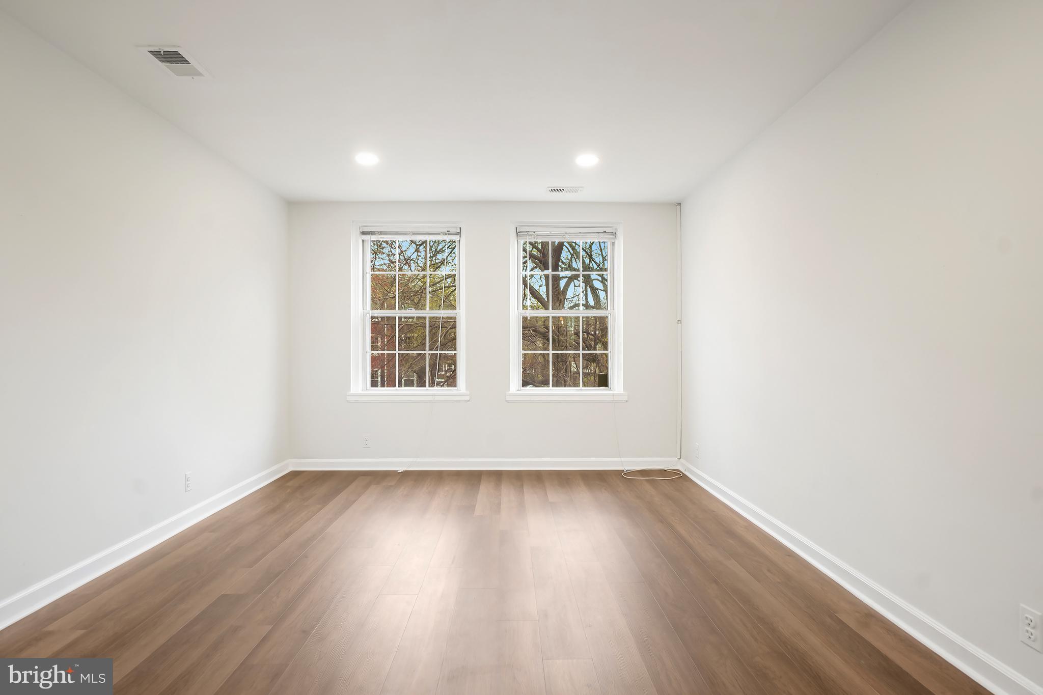 4905 29th Road South, Unit B1 Arlington, VA 22206 - Photo 5 of 52 an empty room with wooden floor and windows