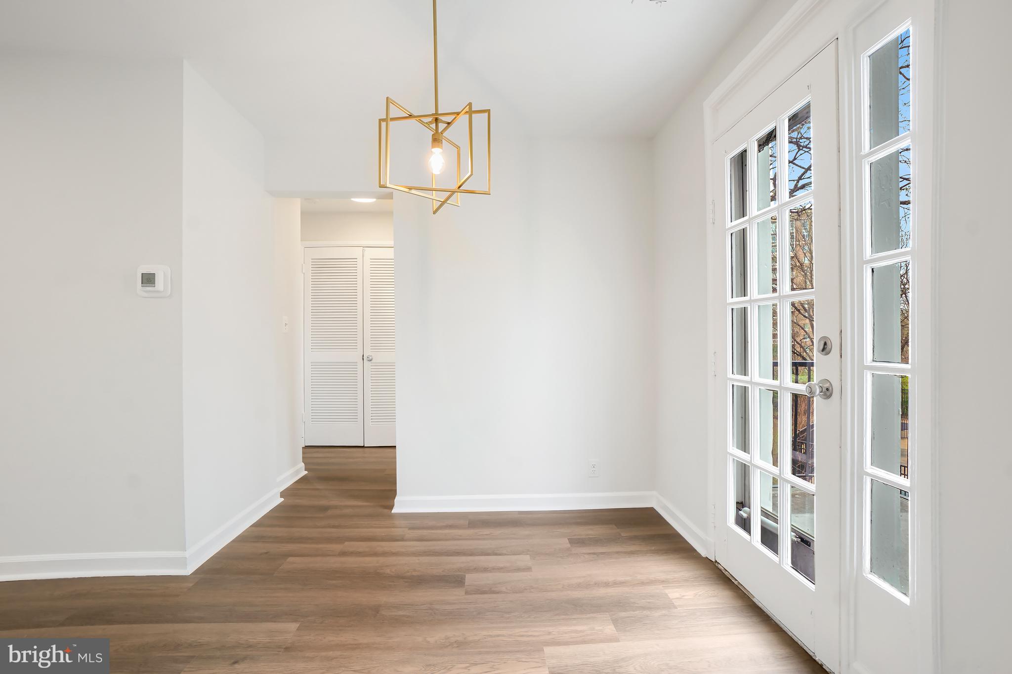 4905 29th Road South, Unit B1 Arlington, VA 22206 - Photo 7 of 52 a view of an empty room with wooden floor and a window