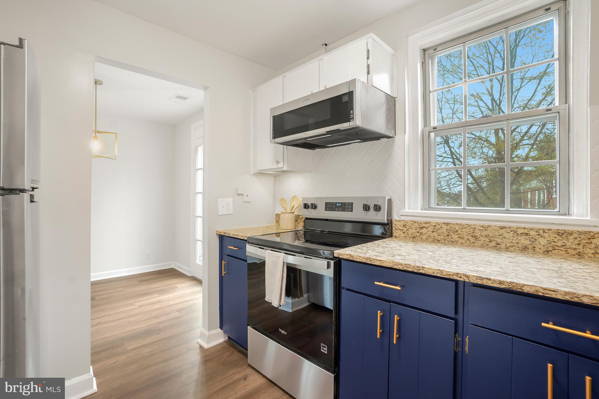 4905 29th Road South, Unit B1 Arlington, VA 22206 - Photo 10 of 52 a kitchen with stainless steel appliances granite countertop a stove a sink and a microwave