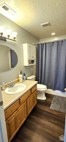 2269 Clear Creek Road Nibley, UT 84321 - Photo 25 of 27 Bathroom with vanity, a textured ceiling, and wood finished floors