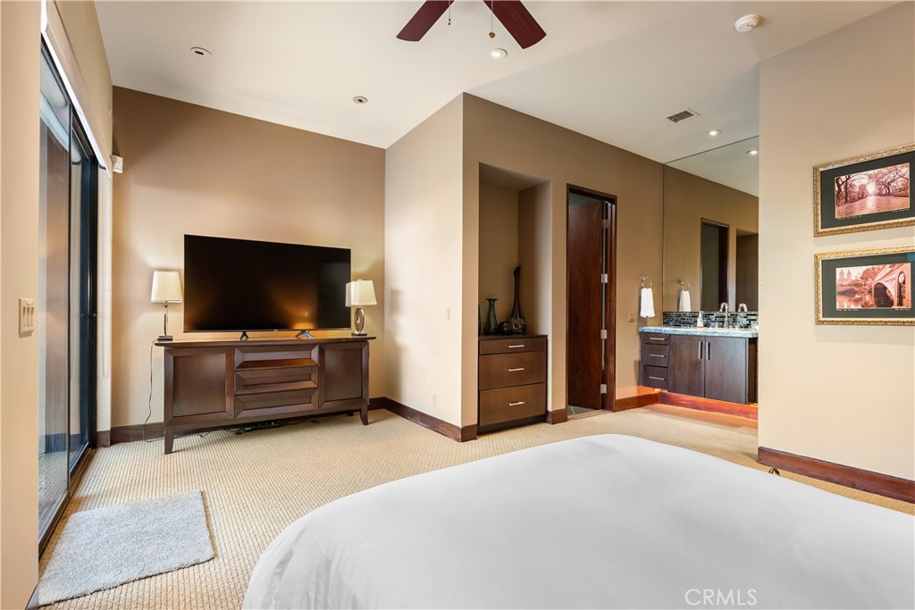 68 Royal St Georges Way Rancho Mirage, CA 92270 - Photo 60 of 75 a bedroom with furniture and flat screen tv