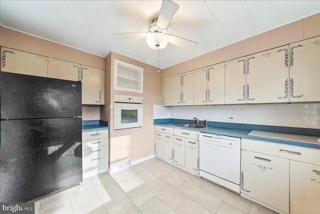 a kitchen with stainless steel appliances a refrigerator sink and cabinets