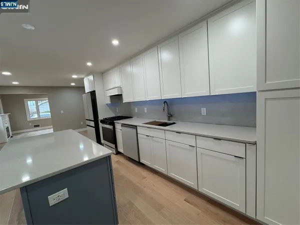 a kitchen with stainless steel appliances granite countertop a sink and cabinets