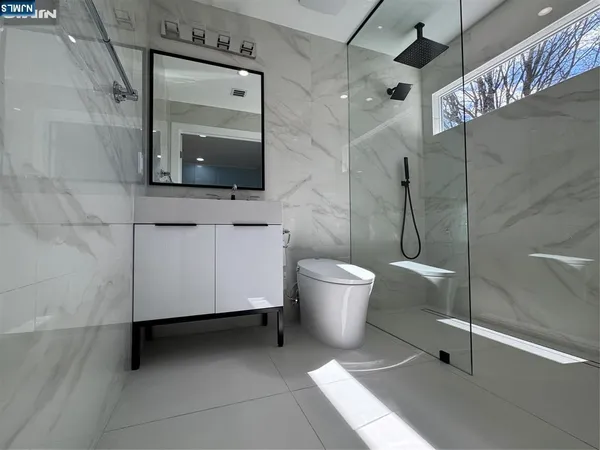 a bathroom with a toilet sink and shower