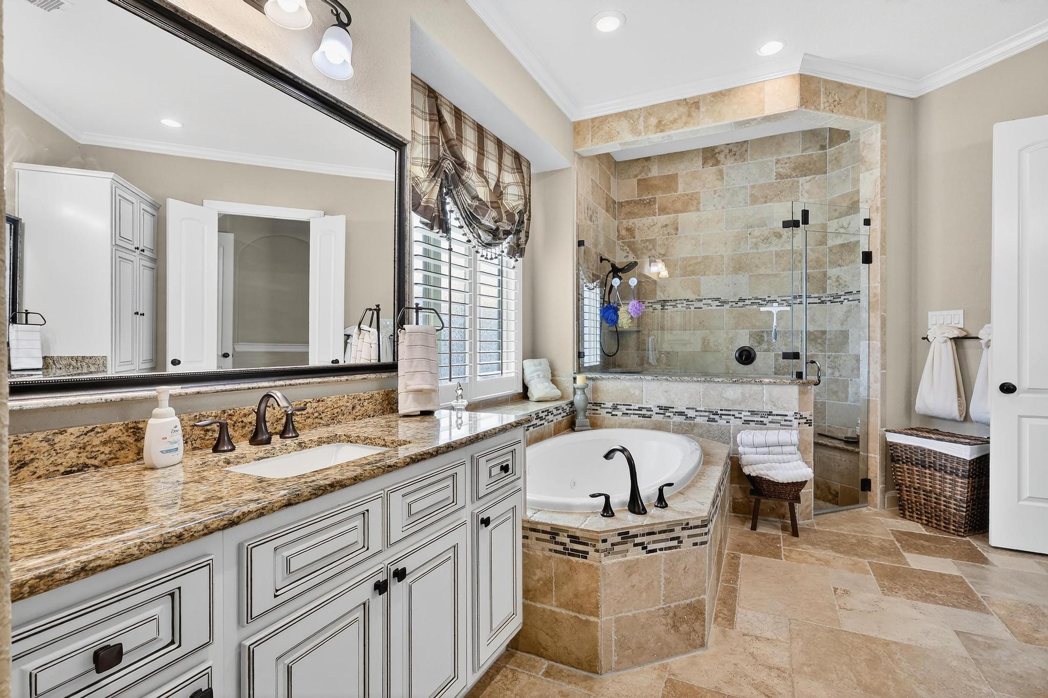 25803 Heritage Maple Drive Spring, TX 77389 - Photo 41 of 46 a bathroom with a granite countertop double vanity sink a mirror and a bathtub