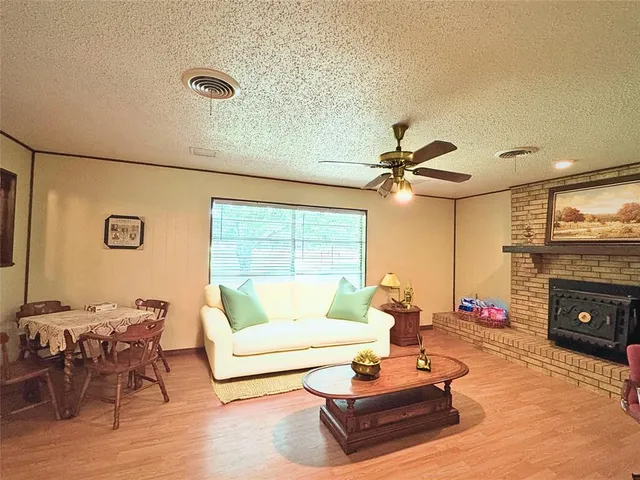 a living room with furniture fireplace and a table