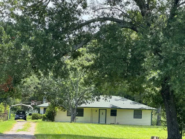 a front view of a house with a yard garage and outdoor seating