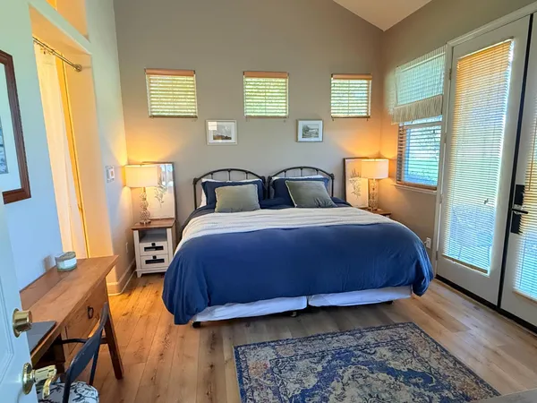 a bed sitting in a bedroom next to a window