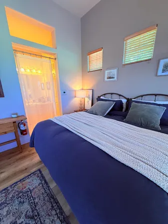 a bedroom with a bed and window