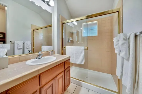 a kitchen with stainless steel appliances kitchen island granite countertop a table and chairs in it