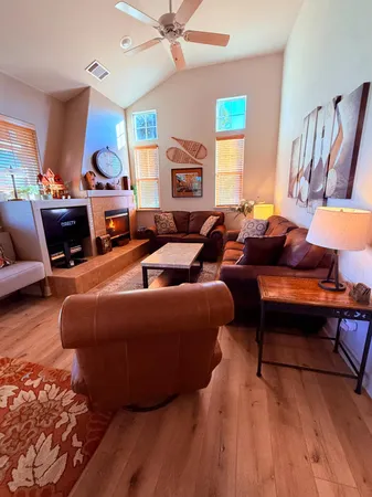 a living room with furniture a fireplace and a large window