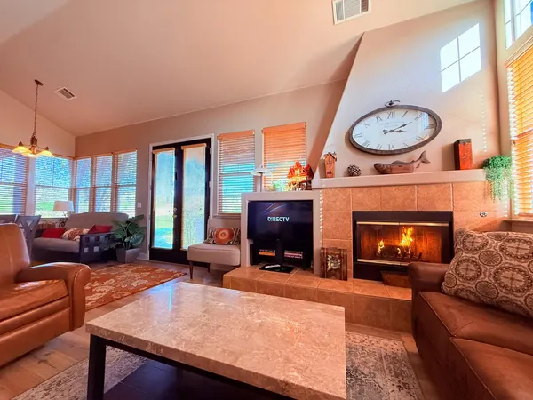 a living room with fireplace furniture and a window