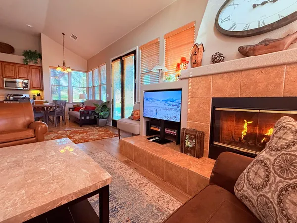 a very nice looking living room with a large window a rug and a view of kitchen