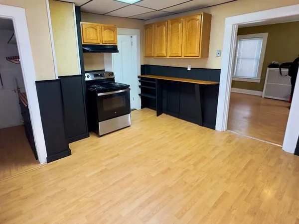 a kitchen with stainless steel appliances a refrigerator and a stove top oven