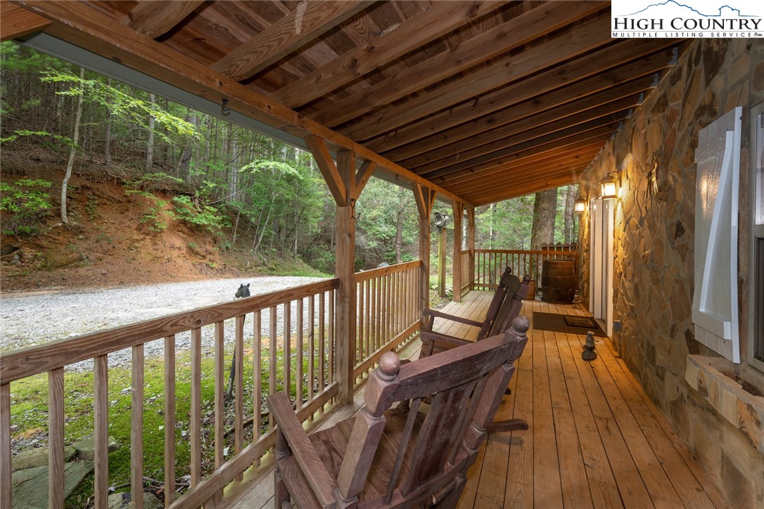 683 Hawkbill Road Ferguson, NC 28624 - Photo 21 of 26 a view of balcony with couch and wooden floor