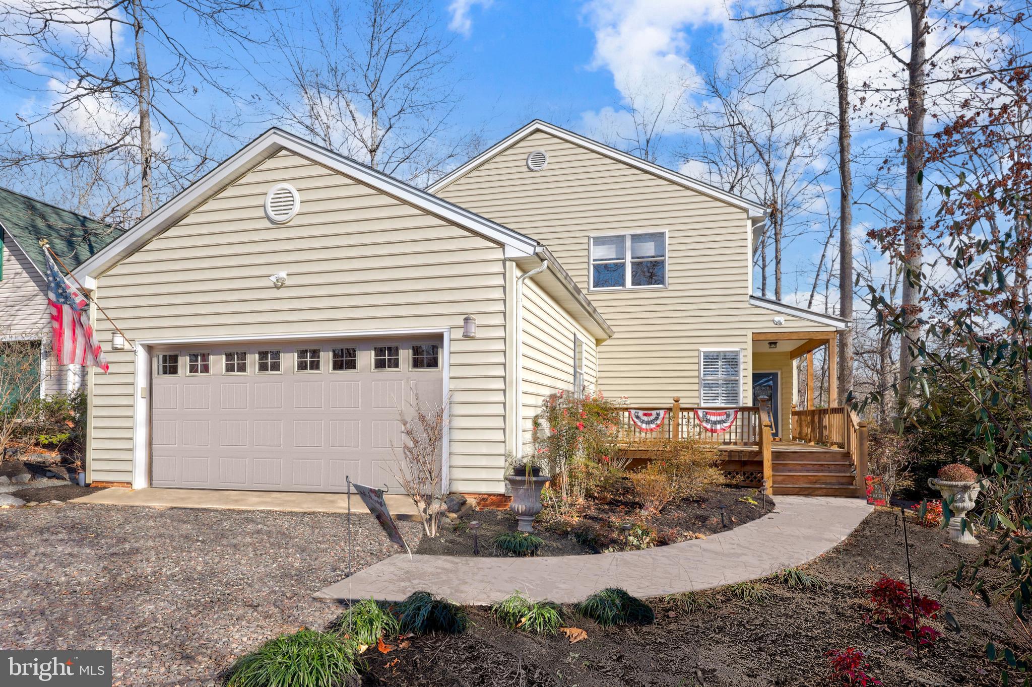 a view of a house with a yard and garage