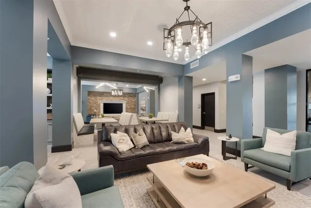 a living room with furniture and a chandelier