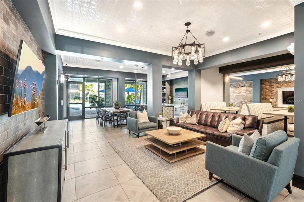 2201 Northwest Federal Highway, Unit 3B1209 Stuart, FL 34994 - Photo 22 of 47 a living room with patio furniture and a chandelier