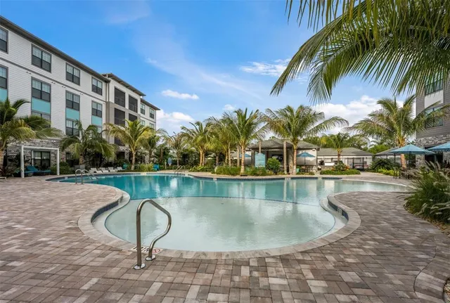 a view of swimming pool with outdoor seating and plants