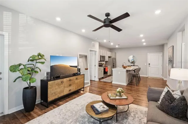 a living room with furniture and a wooden floor