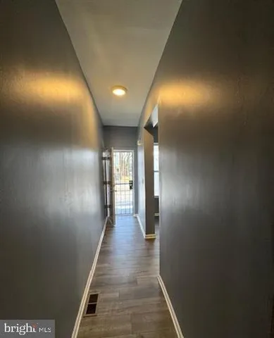 a view of gallery with wooden floor