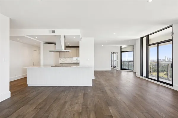 a view of kitchen with stainless steel appliances granite countertop a stove top oven a sink and a large window