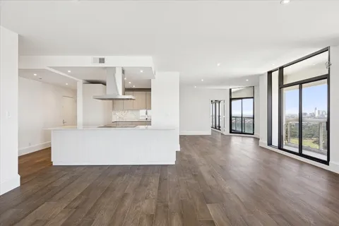 a bathroom with a granite countertop sink a toilet and shower